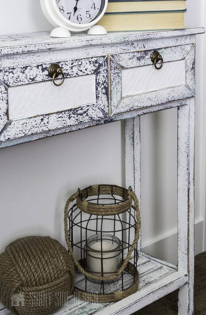 Flea market flip ideas, thrifted console table is transformed with layers of paint with a salt wash finish, staged with monkey fist ball, lantern, clock and books
