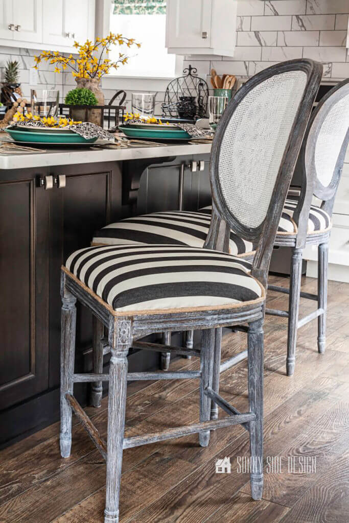 Flea market flip ideas, worn bar stools get a makeover with black and white fabric with a jute cording and the wood gets and update with white wax.
