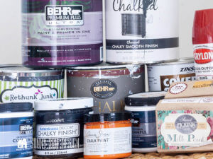 Various cans of different kinds of paints used for painting furniture.