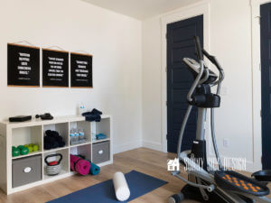Painting a room, finished white painted room with shelves for storing home gym equipments and black and white motivational text art on the wall, eliptical machine, blue yoga mat and white foam roller on the floor, navy blue doors.