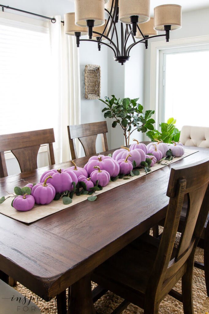 DIY Fall Decor ideas, ombre painted pumpkins across a table runner on a dining tale with eucalyptus branches.
