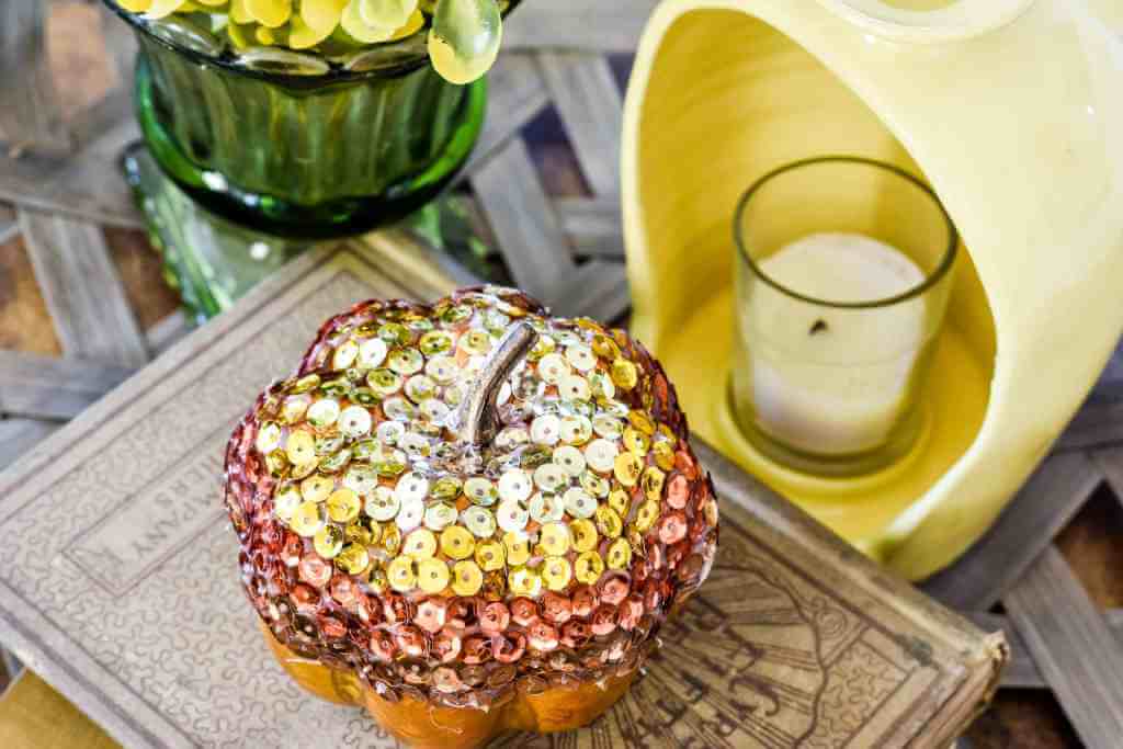 DIY glam pumpkin for fall, sequins are applied in an ombre pattern starting at the top of the pumpkin down about half way.