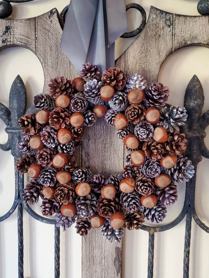 DIY Fall Decor ideas, pinecone wreath on an old iron and wood gate.