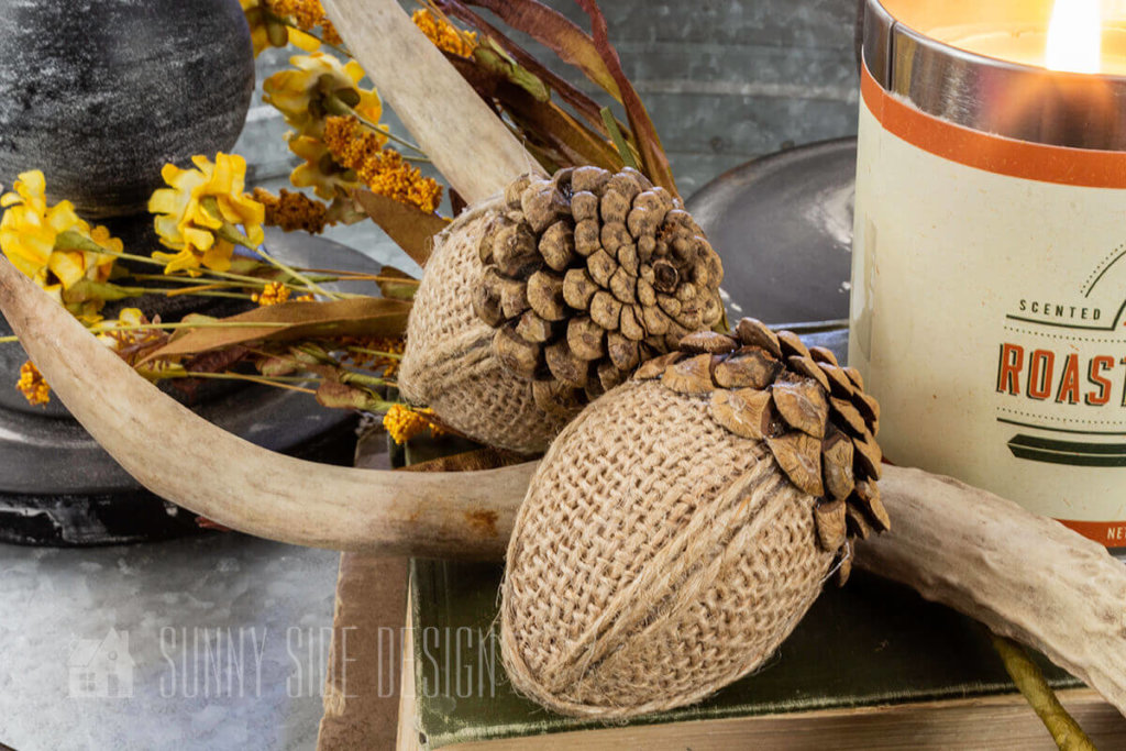 DIY Fall Decor ideas, Burlap and pinecone scale acorns, styled with antlers, sunflowers and a pumpkin candle.