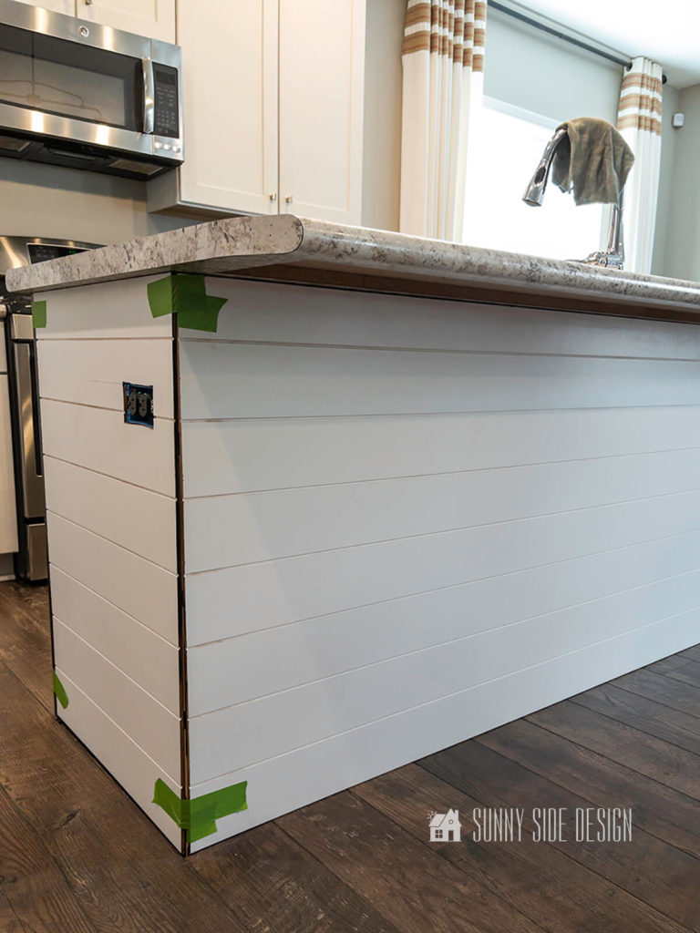 Makeover kitchen island, white primed shiplap panels are taped to the shell of the kitchenland so check fit.