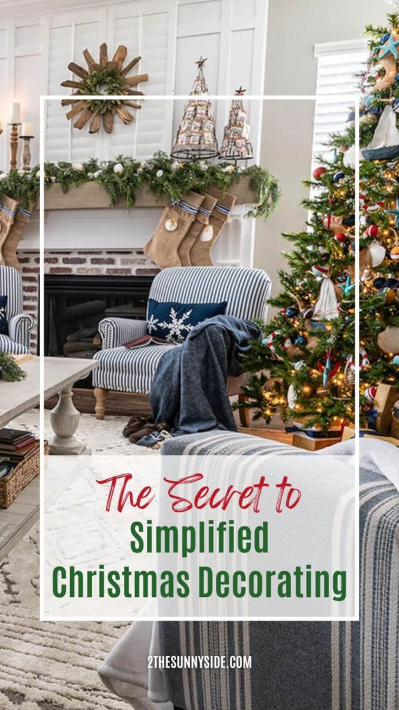 PINTEREST IMAGE Simplified Christmas decorating, living room with simple mantle display with decorated Christmas tree and snowflake pullow on chair