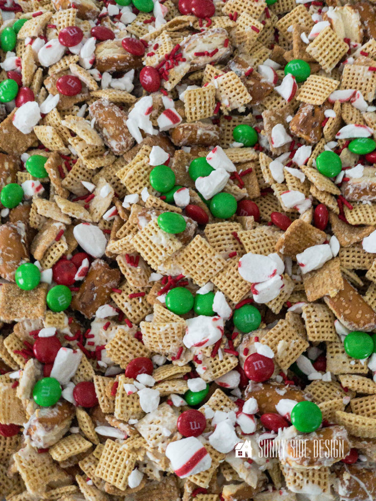 Festive Gift Idea for Neighbors, sweet and salty Christmas Chex mix with red and green M&M candy, peppermint candy and red candy sprinkles.