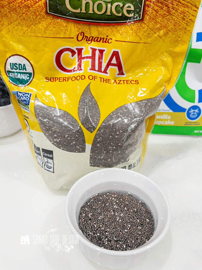 Chia seeds softening in a bowl of water.