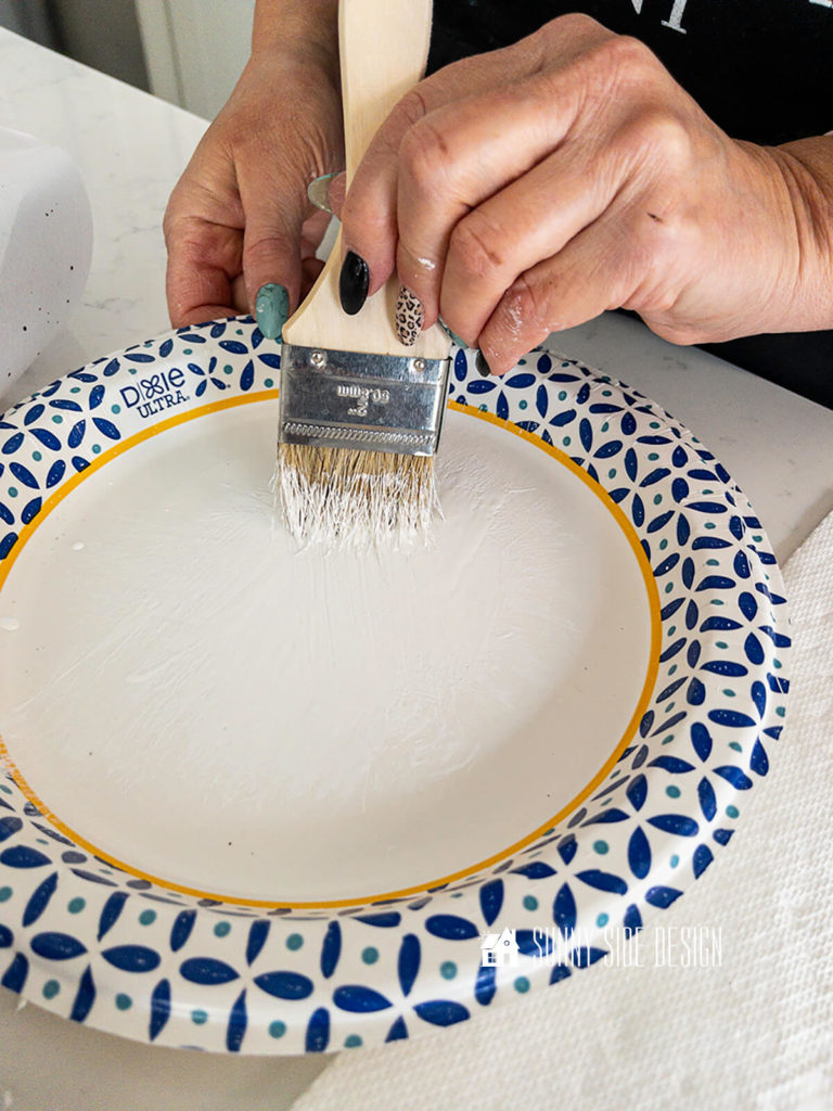 Paint is worked into the bristles of the chip brush.