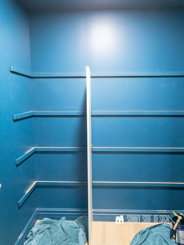 Cleats installed on the wall for the melamine shelves are painted the wall color.