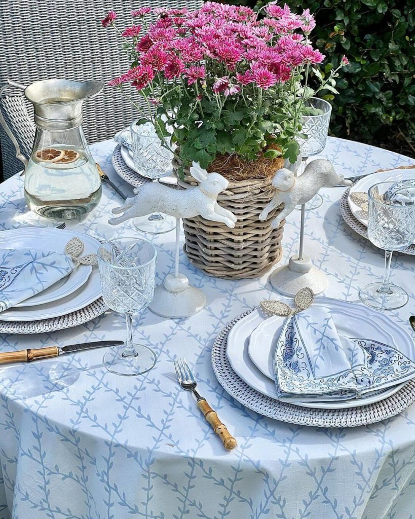 Blue and white spring tablescape with fresh flowers in a basket.