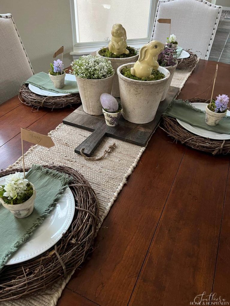 Rustic pots with Easter bunnies and flowers inspire this simple Spring tablescape.