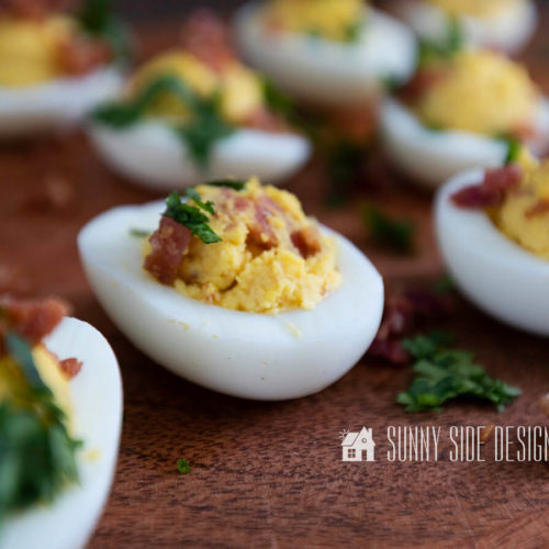 The best deviled eggs recipe garnished with cilantro and bacon.