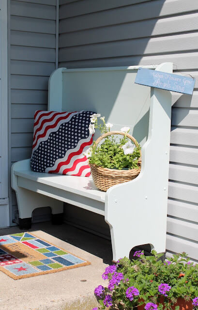 Add color to your small front porch with colorful pillows and rugs.