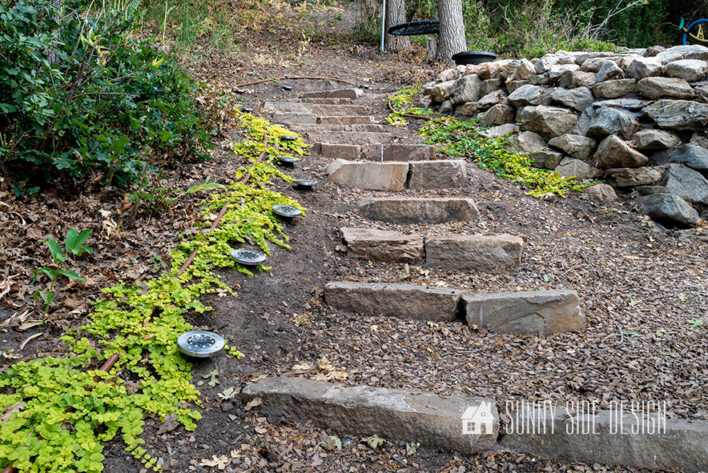 Tackle a steep slope with DIY stone stairs to an outdoor fire pit area.