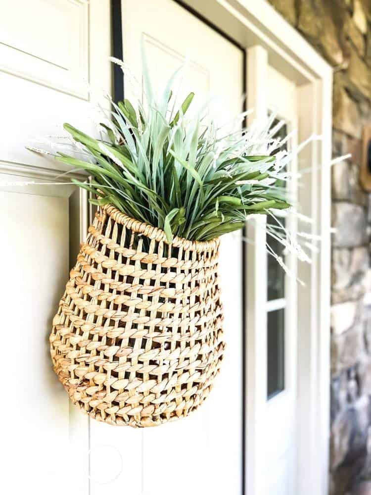 Add style to your front door with a basket filled with greenery and flowers.