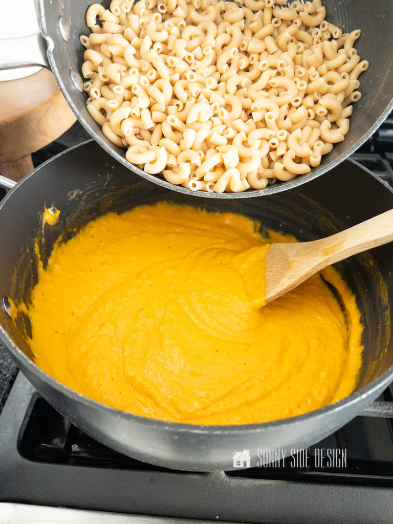 Add cooked whole wheat pasta to the butternut squash and cheese sauce on the stovetop.