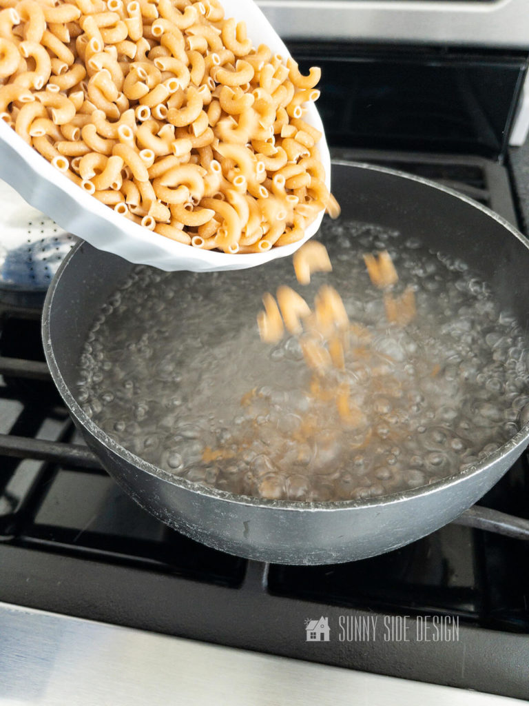 Add whole wheat elbow macaroni to salted boiling water and cook on the stovetop until tender.