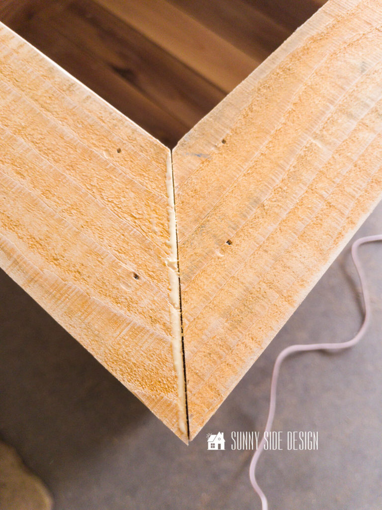 45° cuts on cedar planks form the top trim board for the planter box.