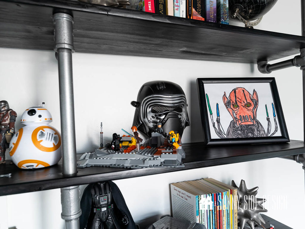 Black Kylo Ren mask with Lego Star Wars figure, and framed child's Star Wars art.