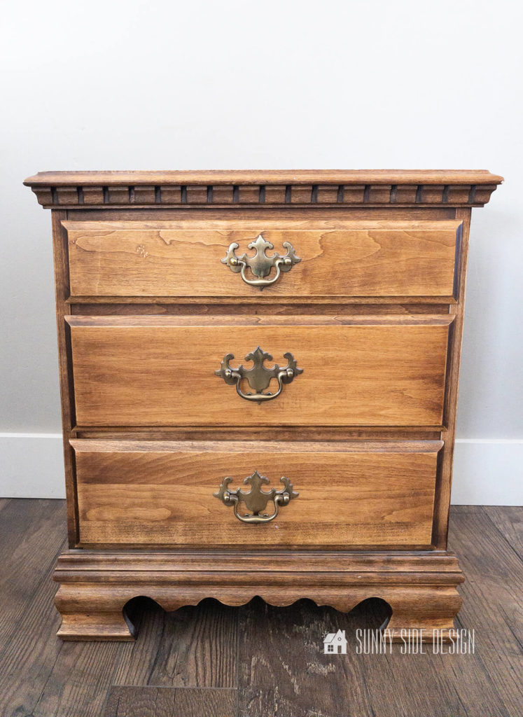 Traditional nightstand with colonial details before a modern makeover.