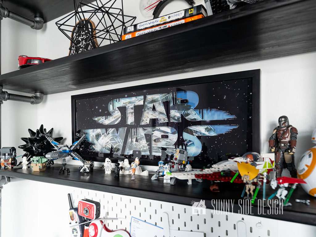Lego Star Wars action figures displayed on a wood and pipe shelf.