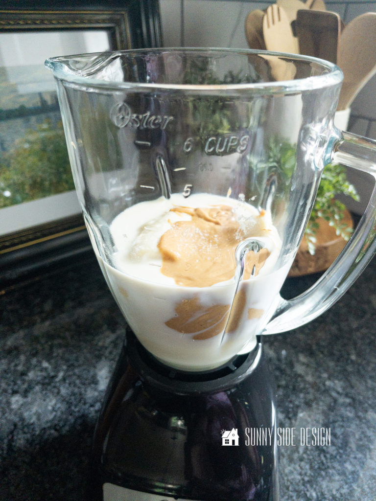 Ingredients are placed in a glass blender container, milk, sugar, vanilla, banana, peanut butter.