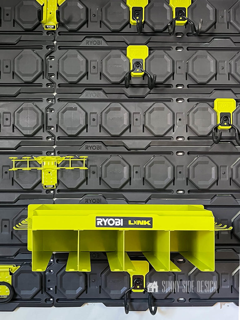 Tool holder and hooks are mounted onto the grey Ryobi Link garage wall storage.