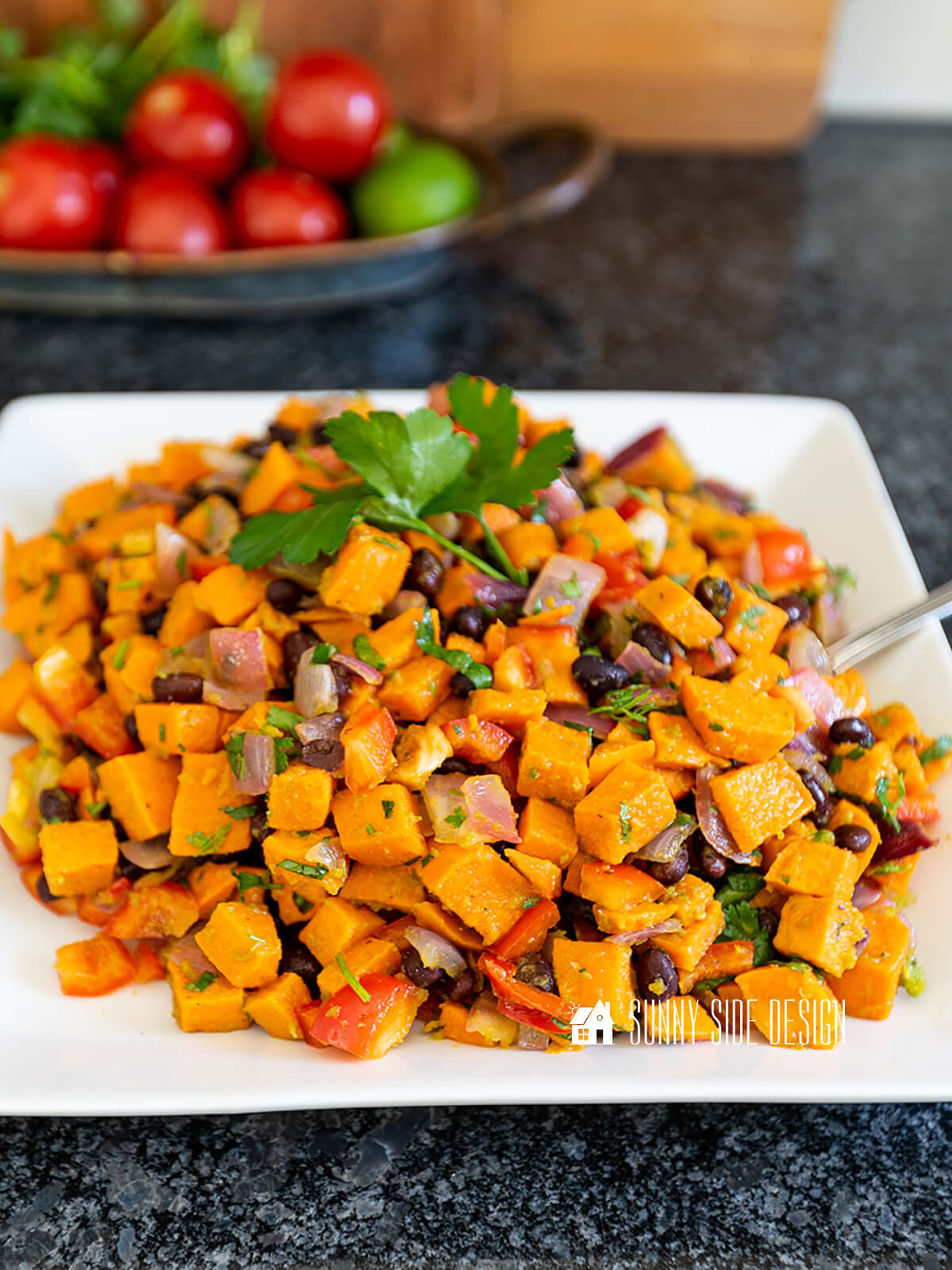 Easy roasted sweet potato salad on a white square serving dish.