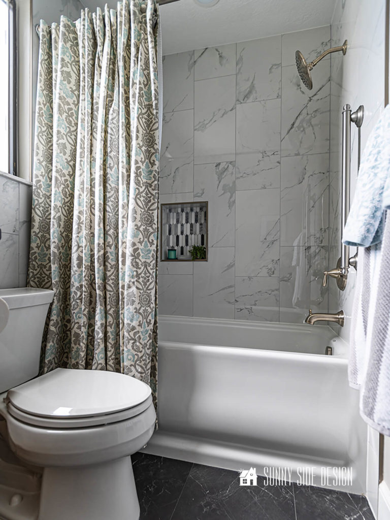 Elevate the look of a bathroom with a custom blue and gray shower curtain.