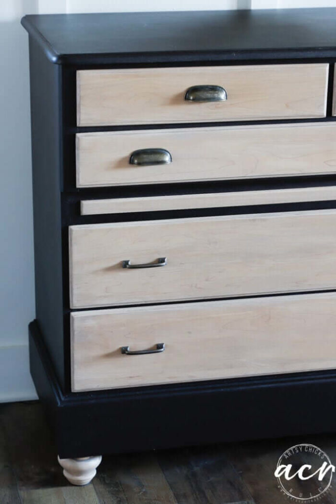 To keep your bedroom on a budget reinvent an old piece of furniture with black paint and natural wood drawers. Sleek modern pulls tie this look together for the masculine design idea.