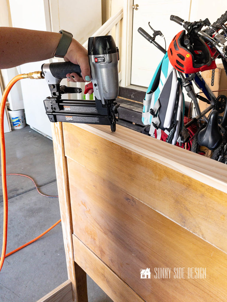 A pneumatic nail gun is used to attach the cap to the top of the headboard.