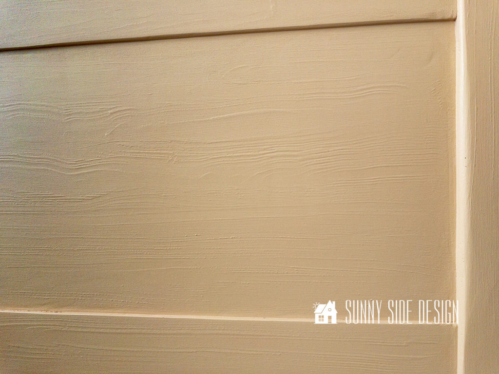 Paint is applied to the headboard after the wood graining layer has dried.