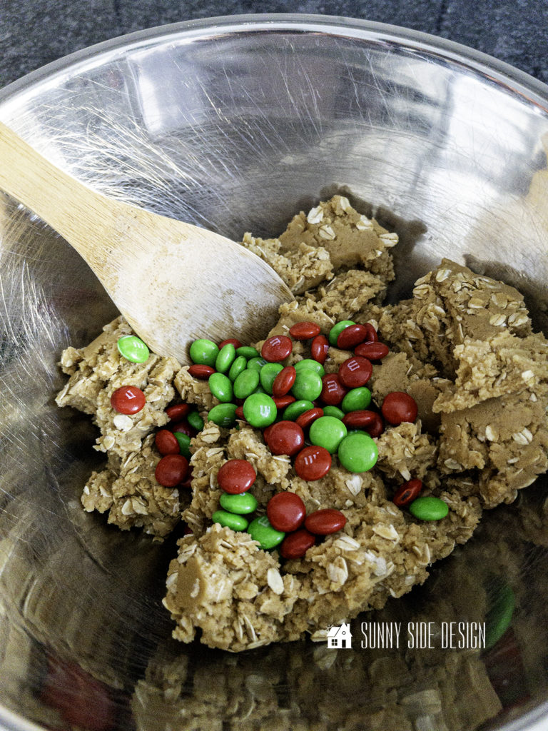 Red and green M&M candies are added to the peanut butter oatmeal cookies dough.