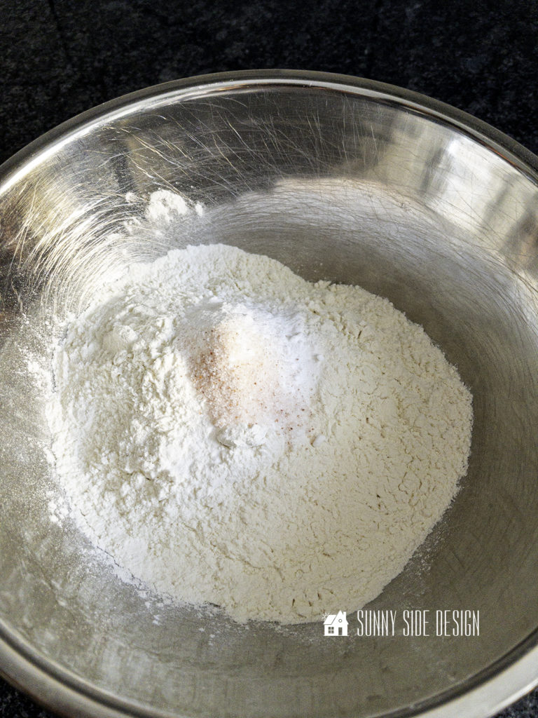 Flour, salt and baking soda in a stainless steel bowl are combined prior to adding to the creamed mixture.