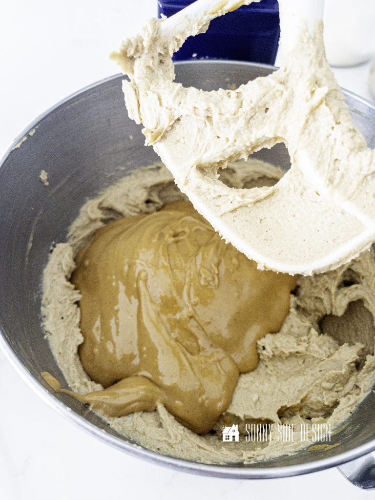 Creamy peanut butter is added to the creamed butter and sugars.