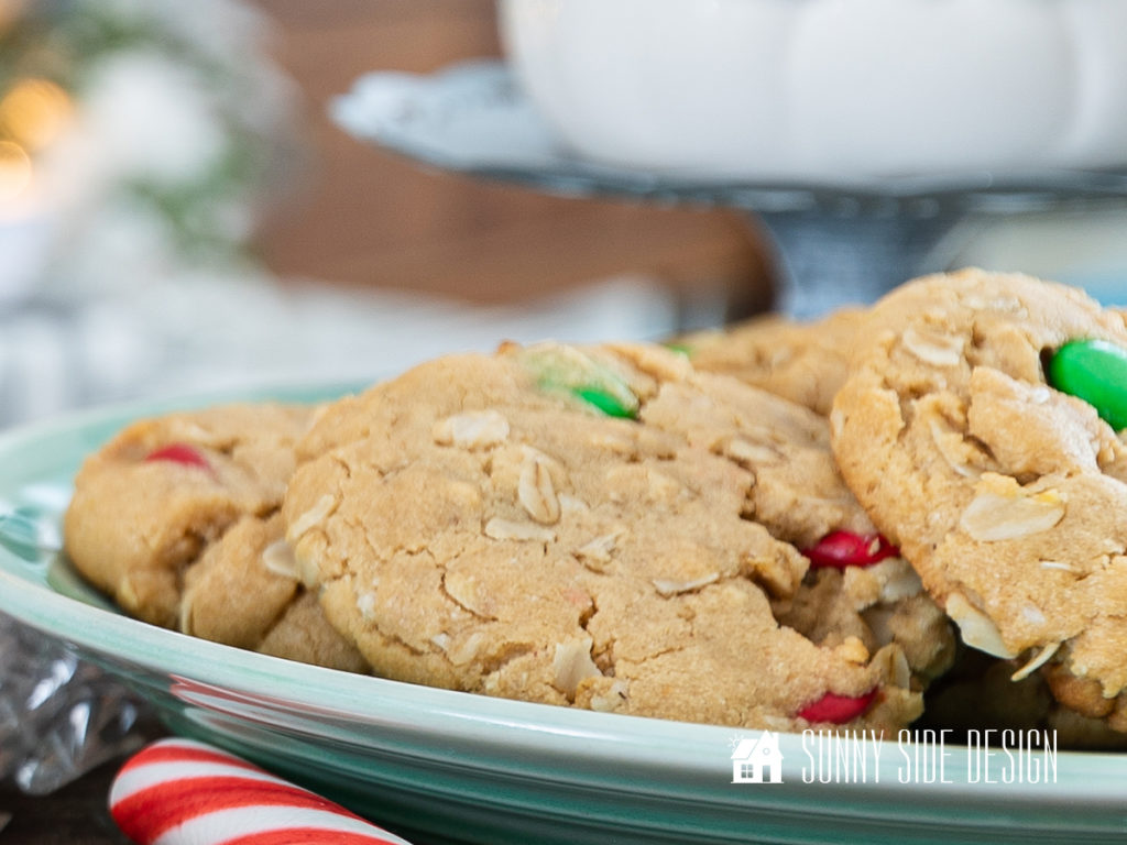 Peanut butter oatmeal cookies with M&M candies on a green plate.