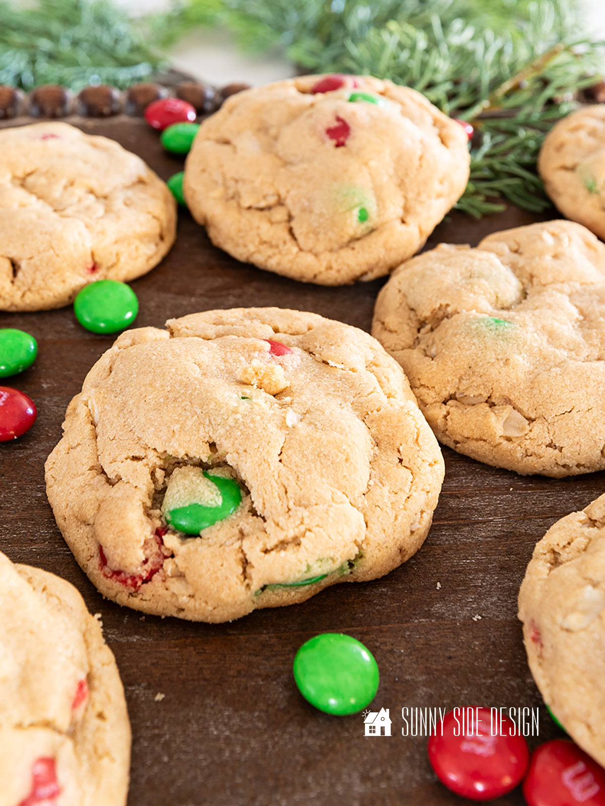 Peanut butter oatmeal cookies with M&M candies on a serving tray with red and green M&M candies.