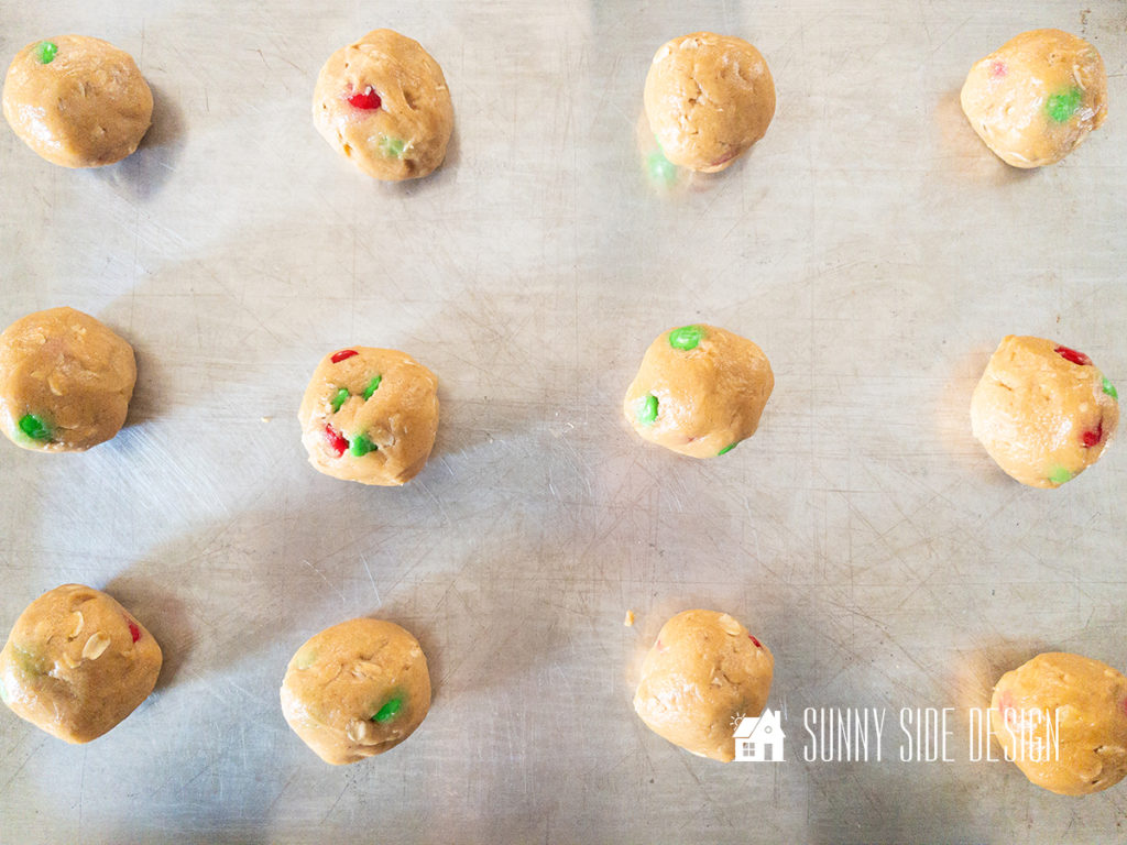 Peanut butter oatmeal cookie dough rolled into balls and placed on a cookie sheet prior to baking.