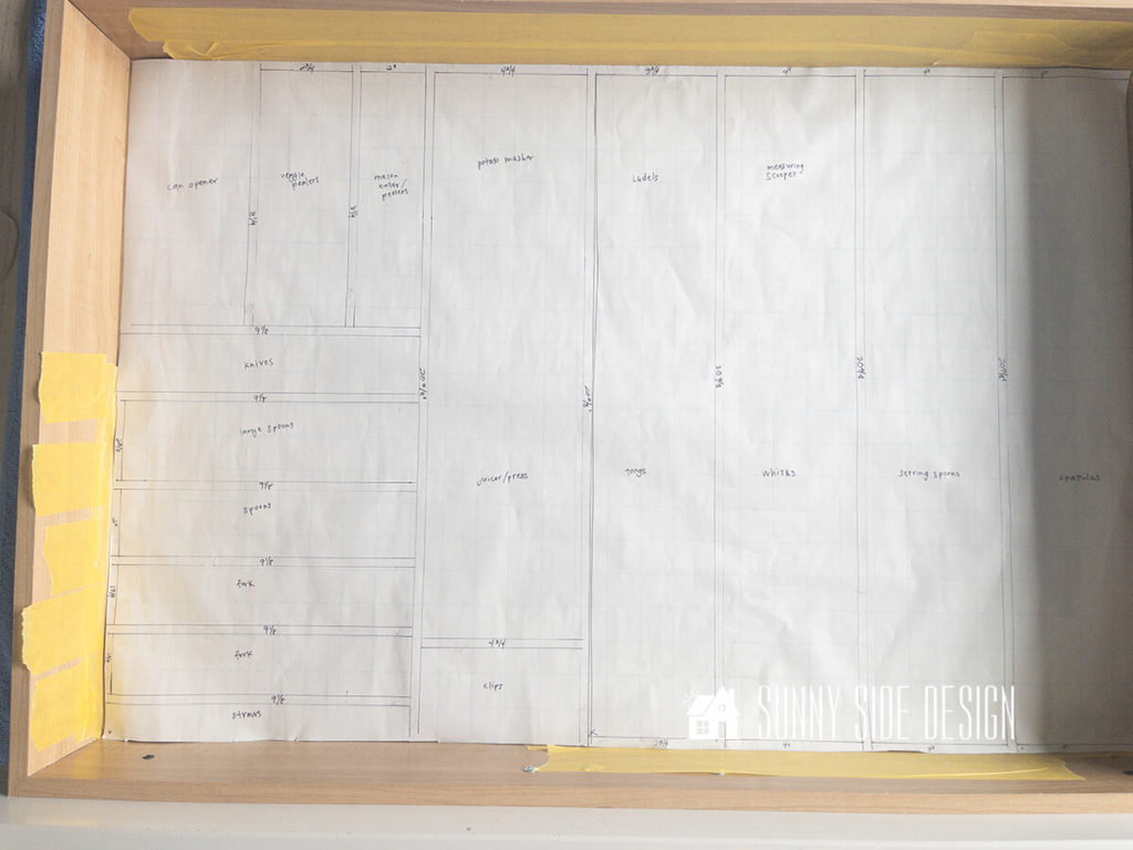 Drawer organizer plan on paper placed in the drawer.