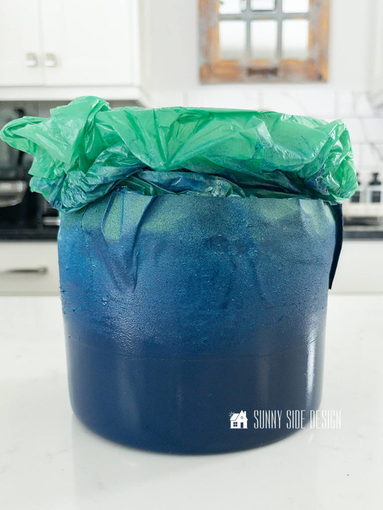 Navy blue spray paint applied to clear glass vase for color block vase dupe.