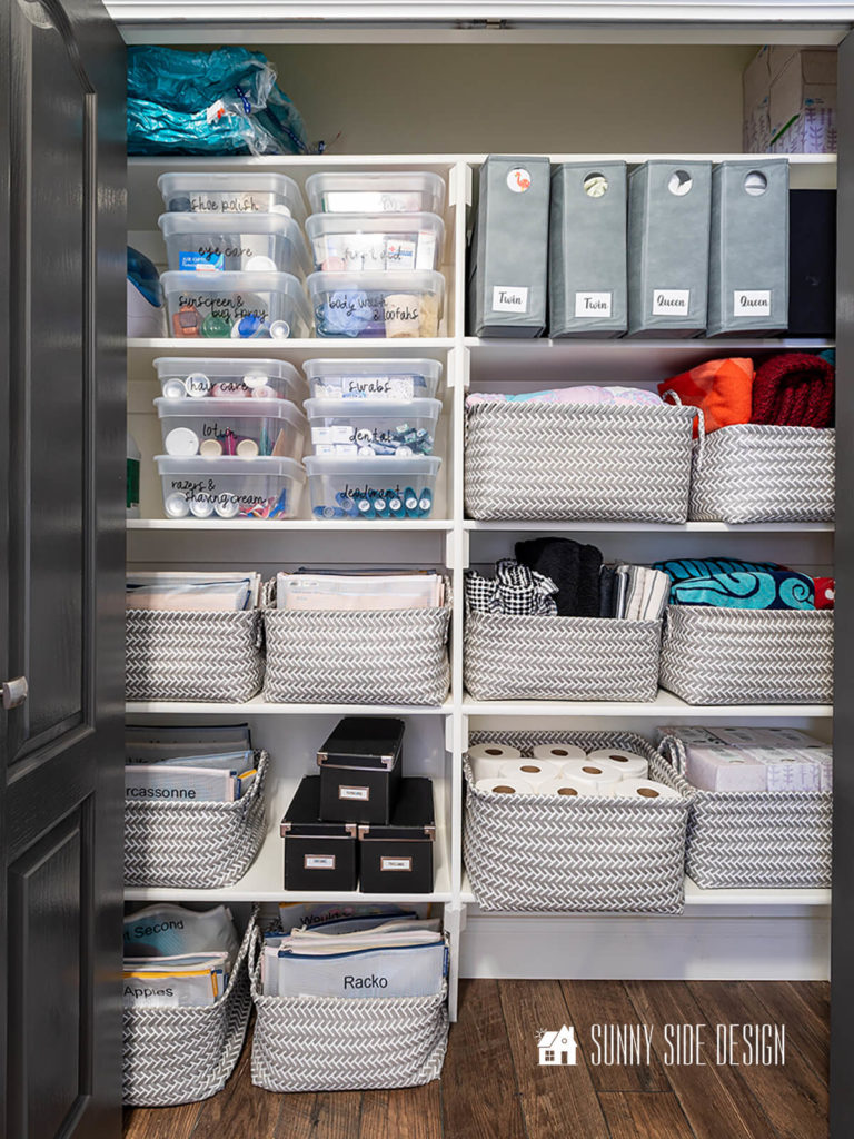 Organize a linen closet with baskets and clear labeled lidded containers.