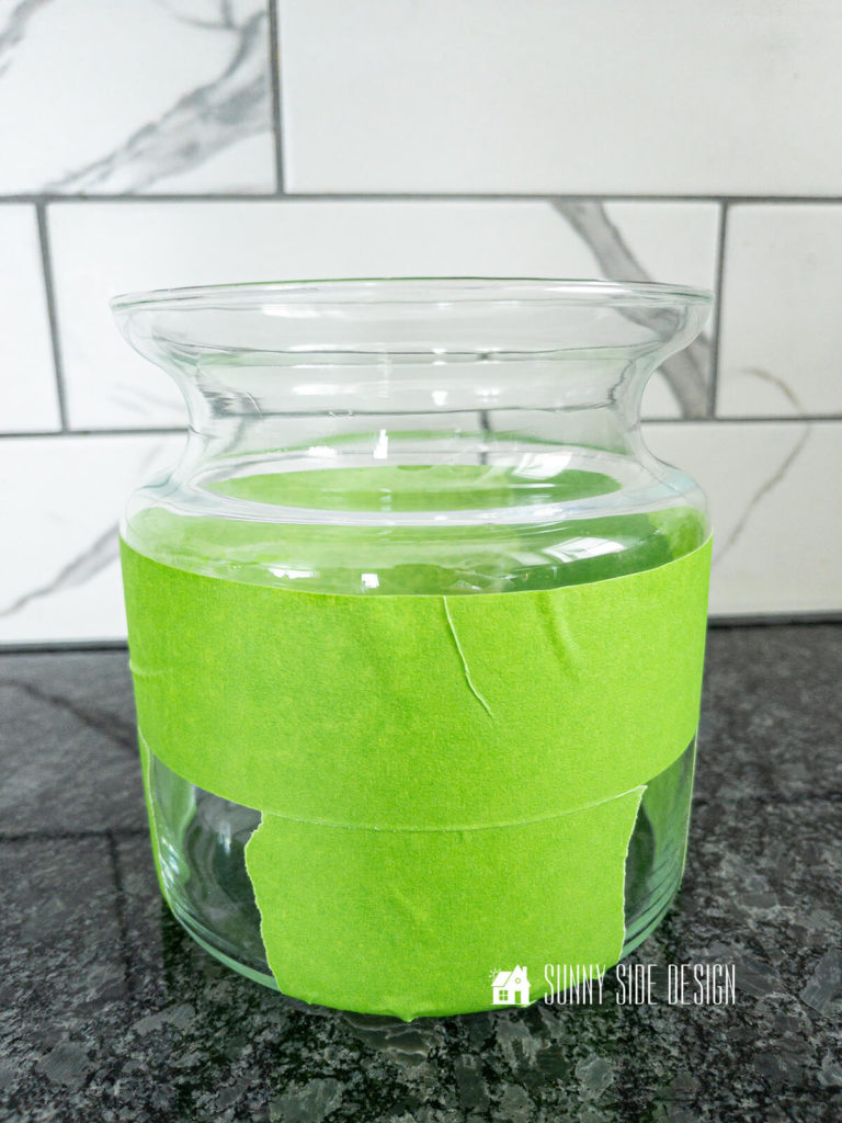 Green painters tape applied to thrifted clear glass vase.