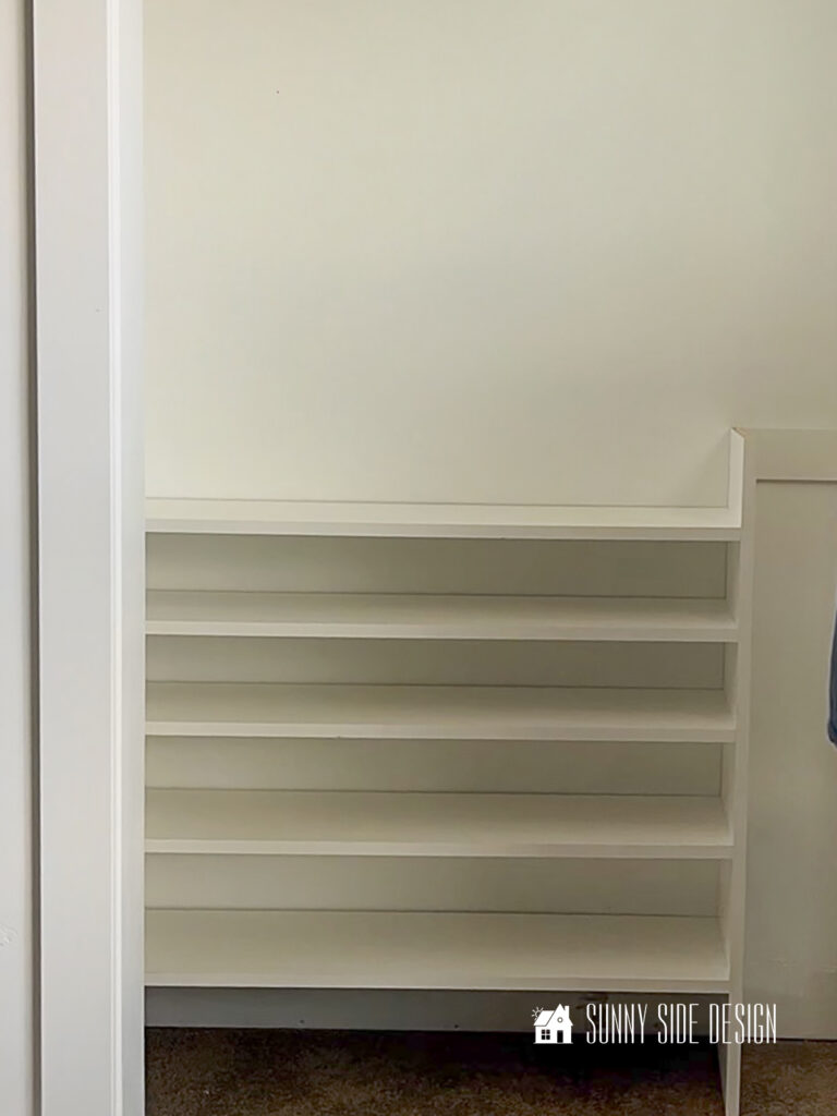 Shoe organizer is attached to the side wall of closet and cleat.