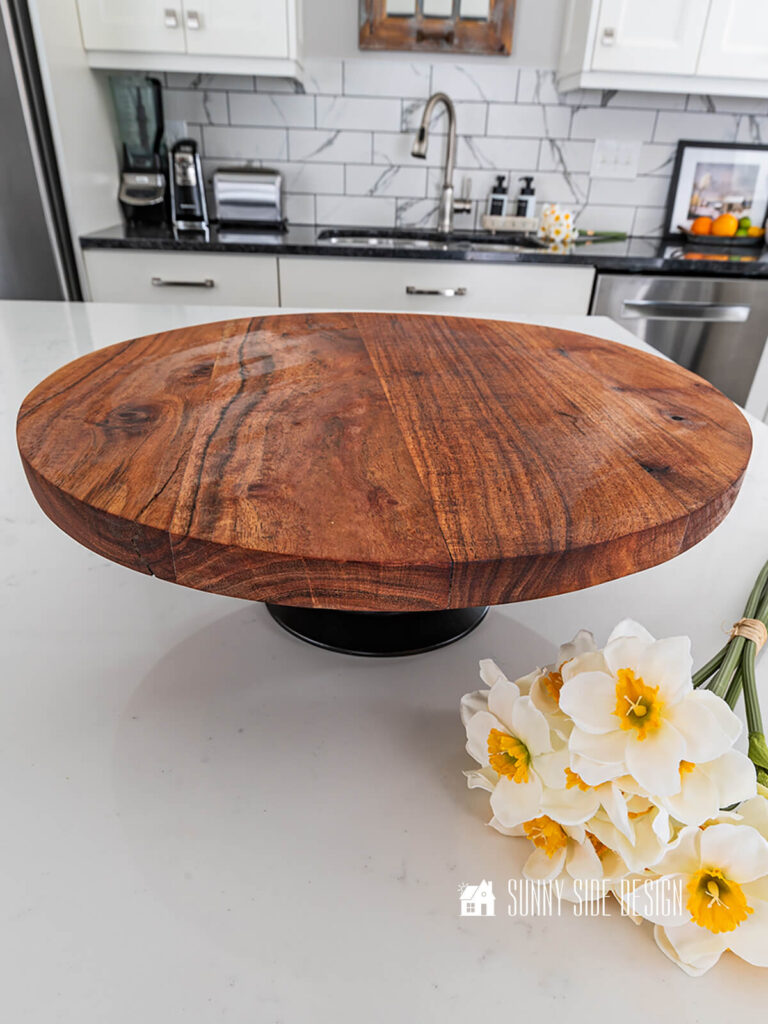Finished pedestal serving tray styled on the kitchen island with a bunch of daffodils.