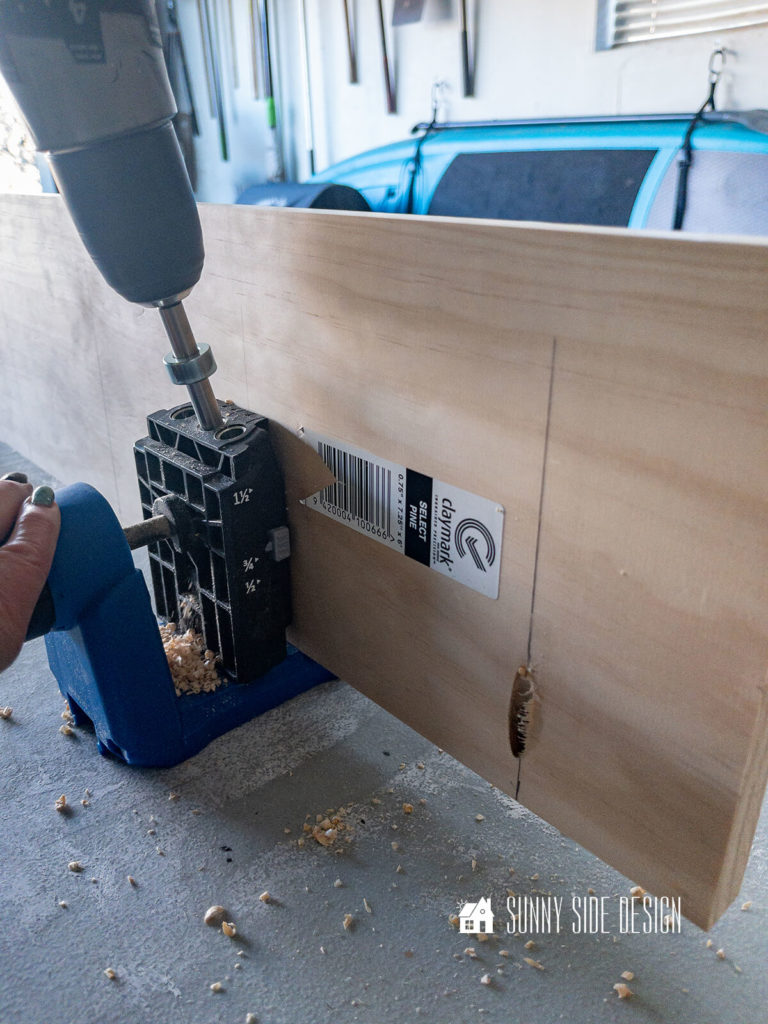 Pocket holes are drilled into a piece of wood to create a top for the hutch makeover.