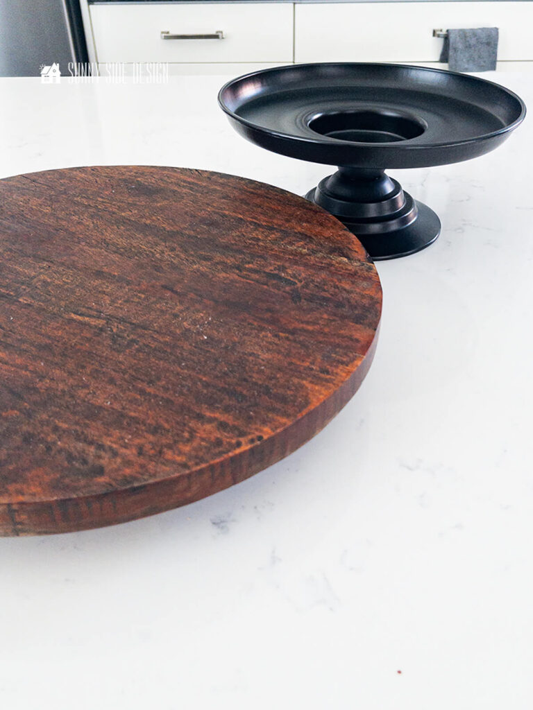 Thrift store finds, black metal raised base and a round wooden lazy susan.
