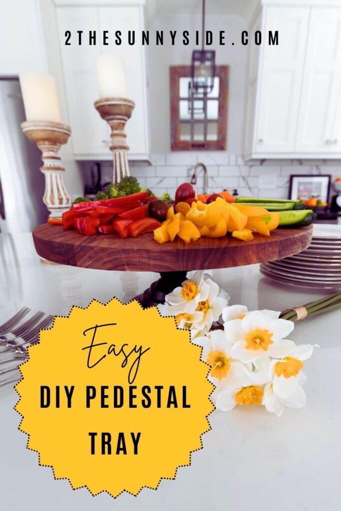 PINTEREST IMAGE: DIY PEDESTAL SERVING TRAY STYLED WITH COLORFUL VEGETABLES AND DAFFODILS.