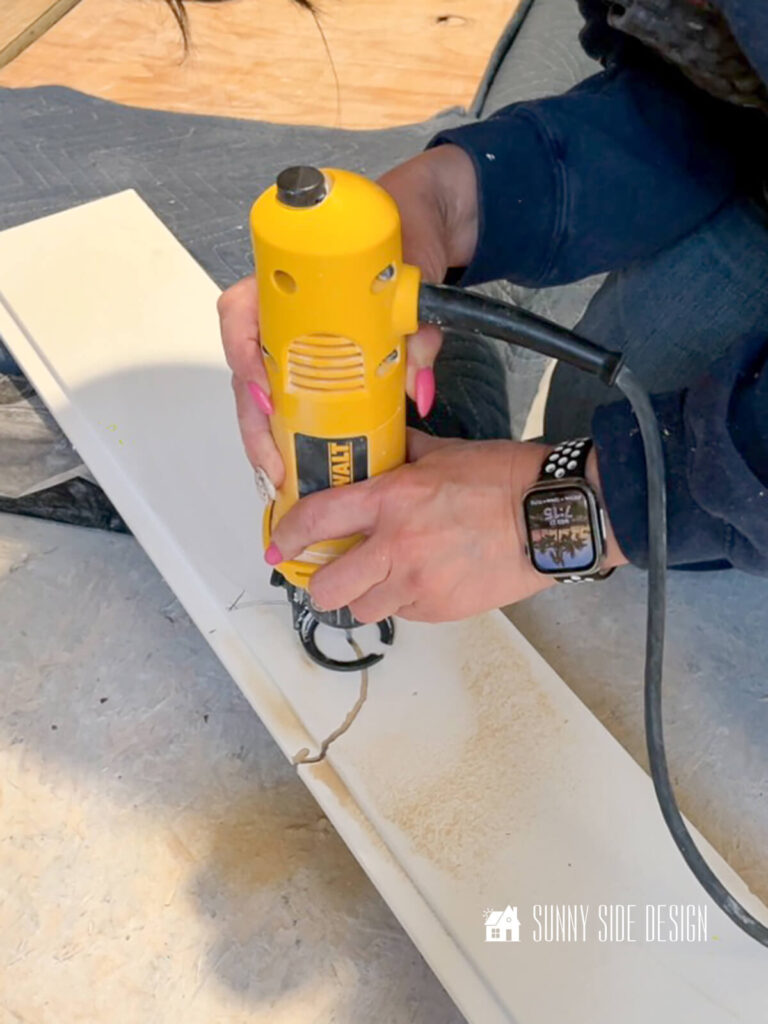 Cuts are made in shiplap for ceiling light fixtures.