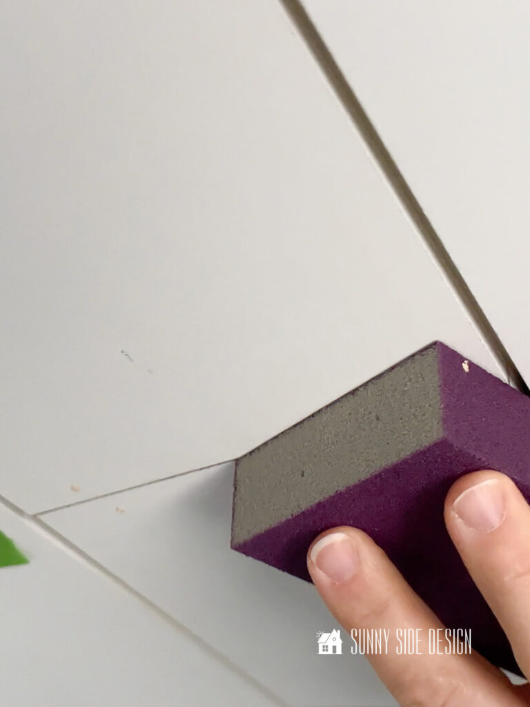 Sand wood filler on shiplap bathroom ceiling.